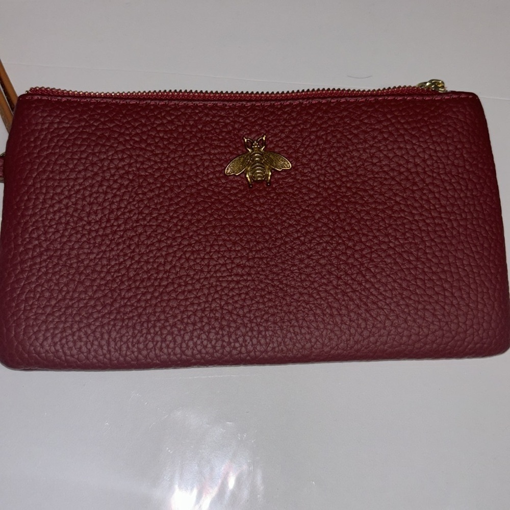 RED PEBBLED LEATHER WRISTLET WITH BRASS BEE ADORNMENT WITH TAN WRISTLET STRAP